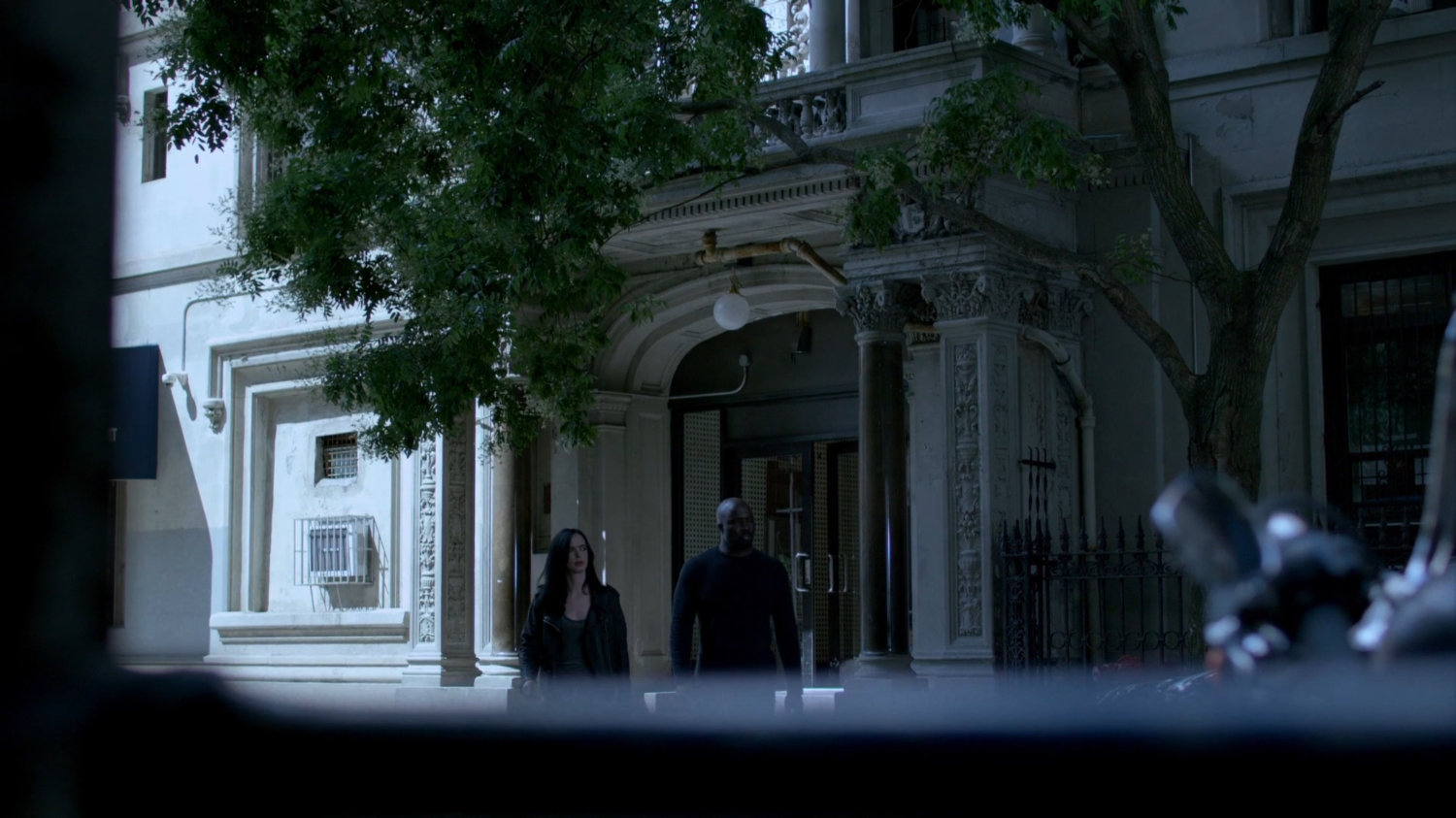 Luke and Jessica crossing street in front of Alias Investigations building.