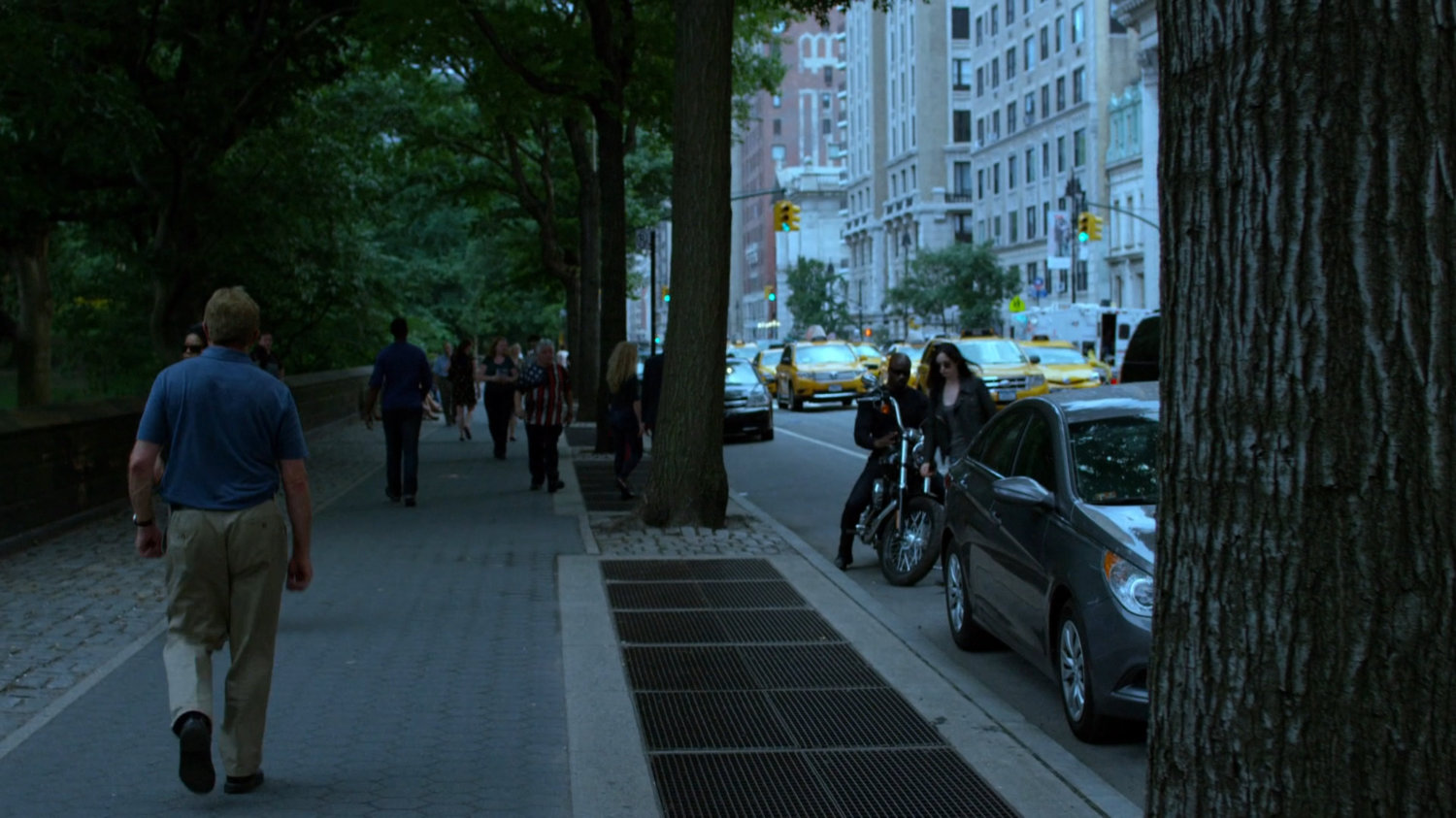 Luke and Jessica pulling up to sidewalk by park.