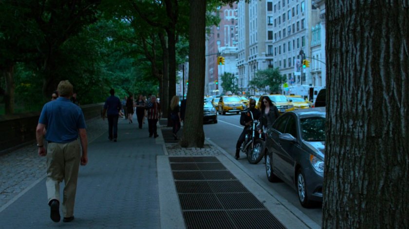 Luke and Jessica pulling up to sidewalk by park.