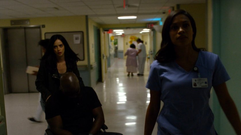 Jessica and Claire wheeling an unconscious Luke down a hallway in Metro-General hospital.