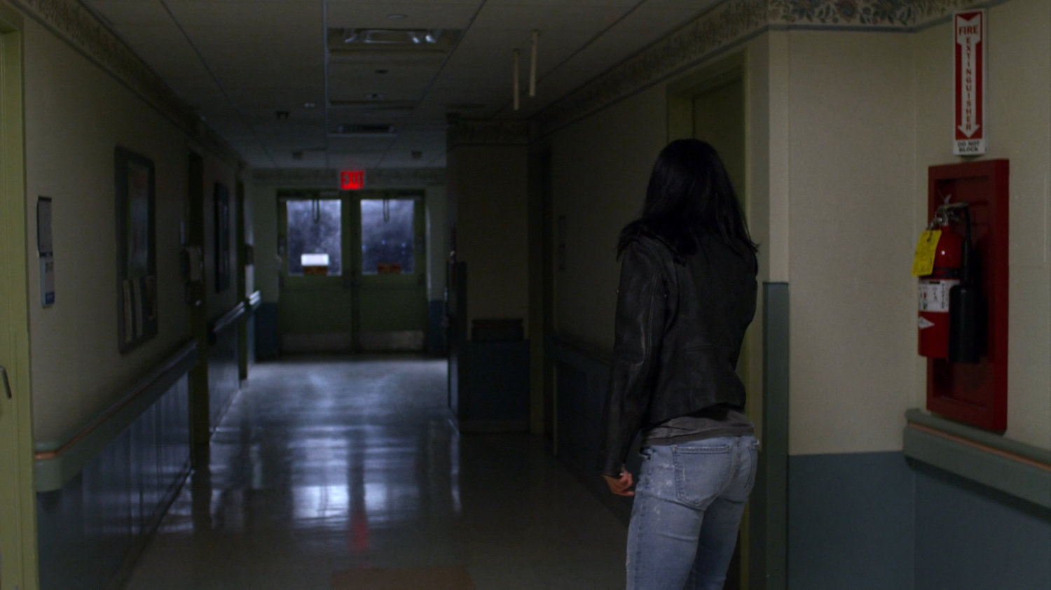 Jessica walking through a Metro-General hallway.