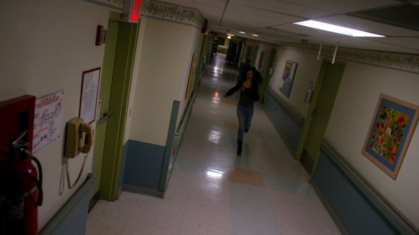 Jessica running through a Metro-General hallway.