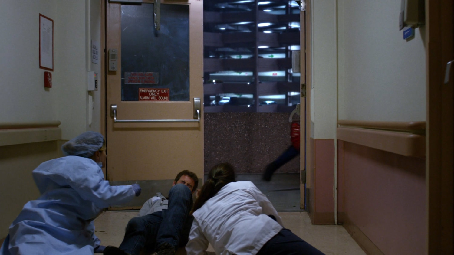 Jessica racing out a Metro-General exit as doctor's lie on the floor.