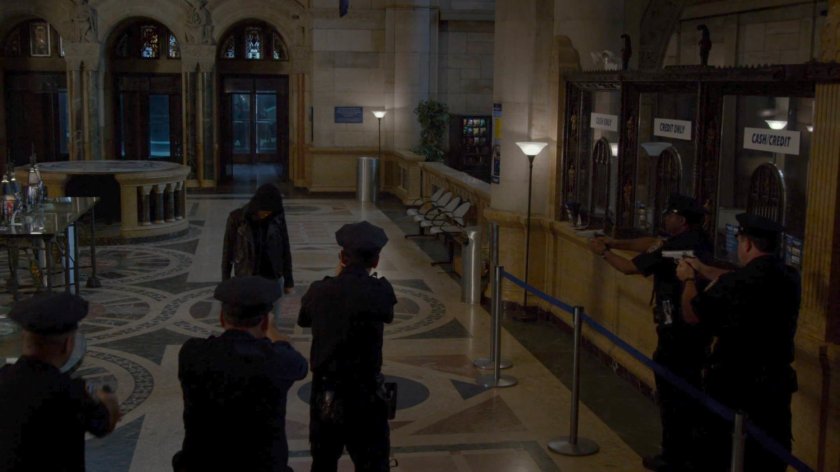 Police officers hold guns on Jessica in Hudson Ferry Terminal.