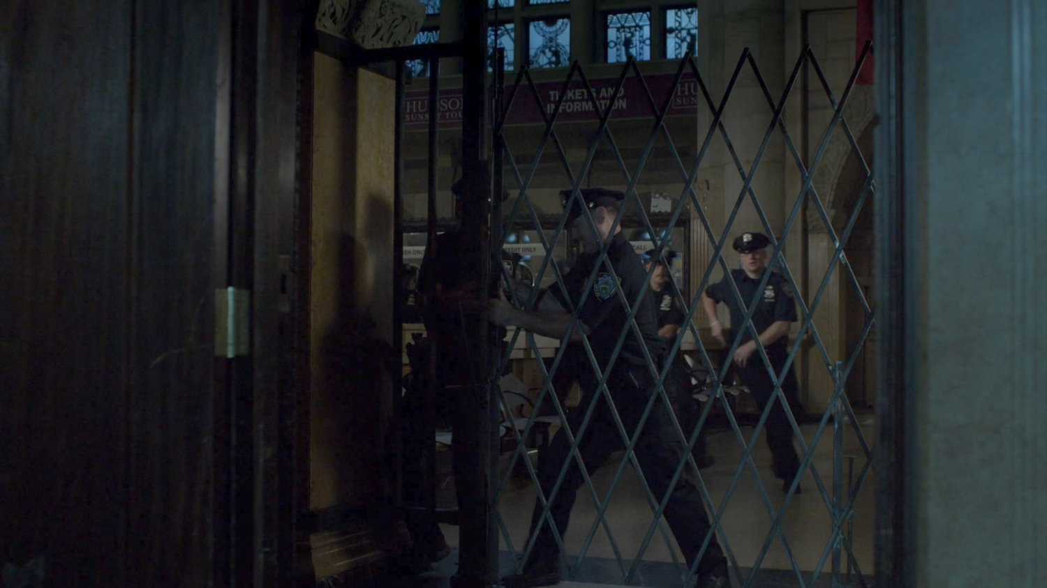 Officers try to open locked screen at Hudson Ferry Terminal.