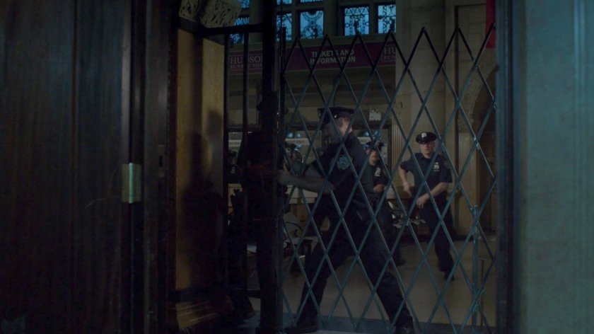 Officers try to open locked screen at Hudson Ferry Terminal.