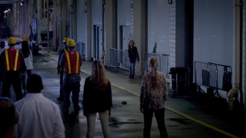 Trish approaches civilians on the Hudson Ferry Terminal dock.