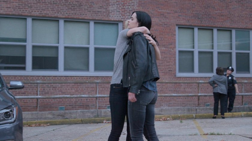 Trish giving Jessica hug in 15th Precinct parking lot.