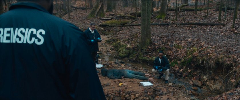 Body near stream in New Jersey woods.