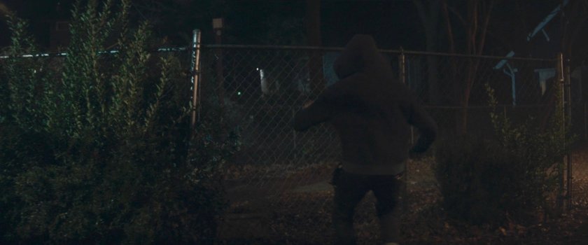 Teen running toward fence behind Agnes's house.