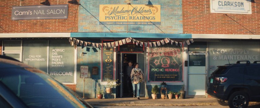 Agatha and teen exiting Madame Calderu's Psychic Readings store.