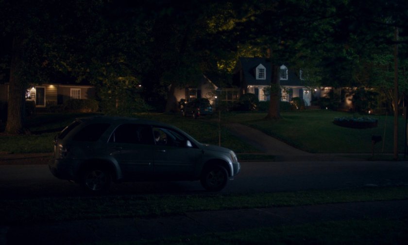 Car parked outside Kaplan house at night.