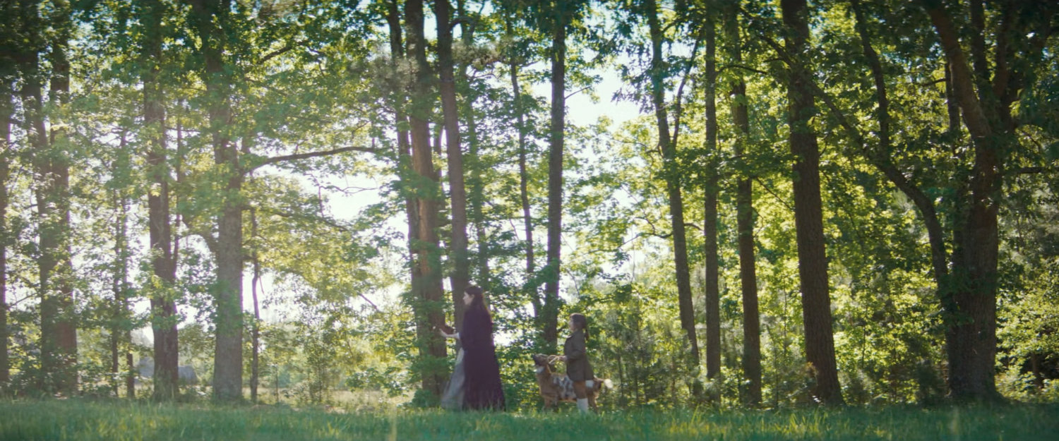 Nicky and Agatha walk along a road outside a settlement, 1756.