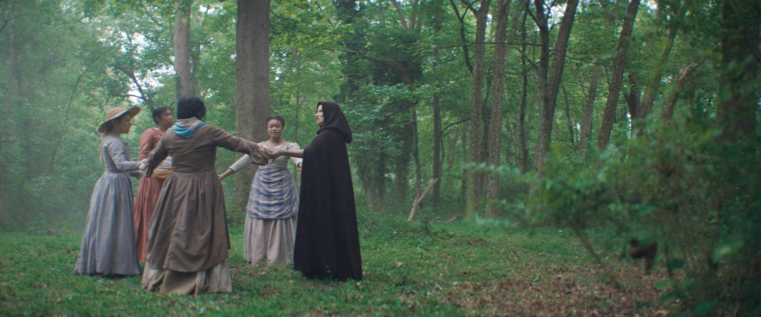Agatha and her coven in the woods.