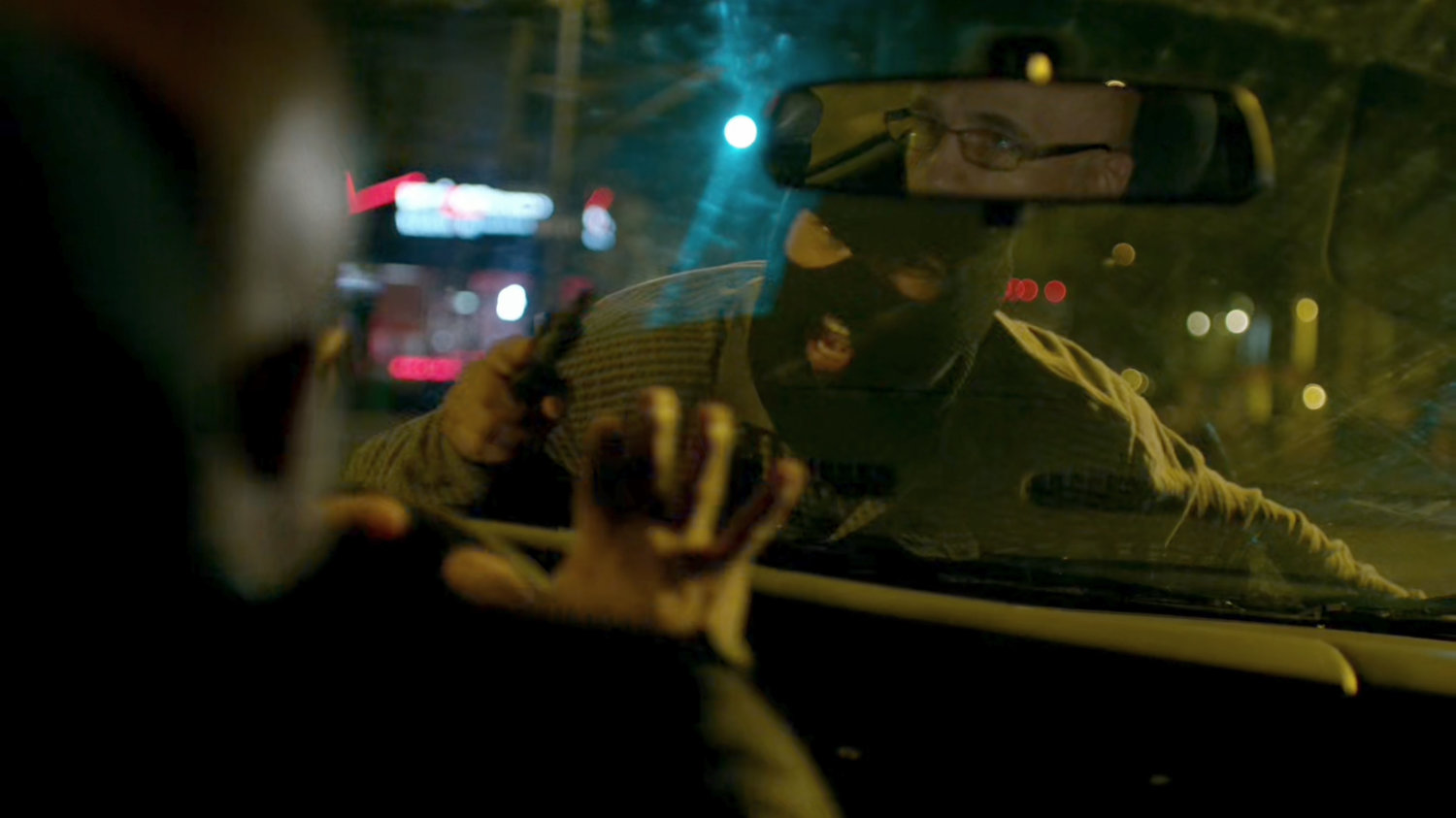 A diamond thief stares through the front windshield at the driver.