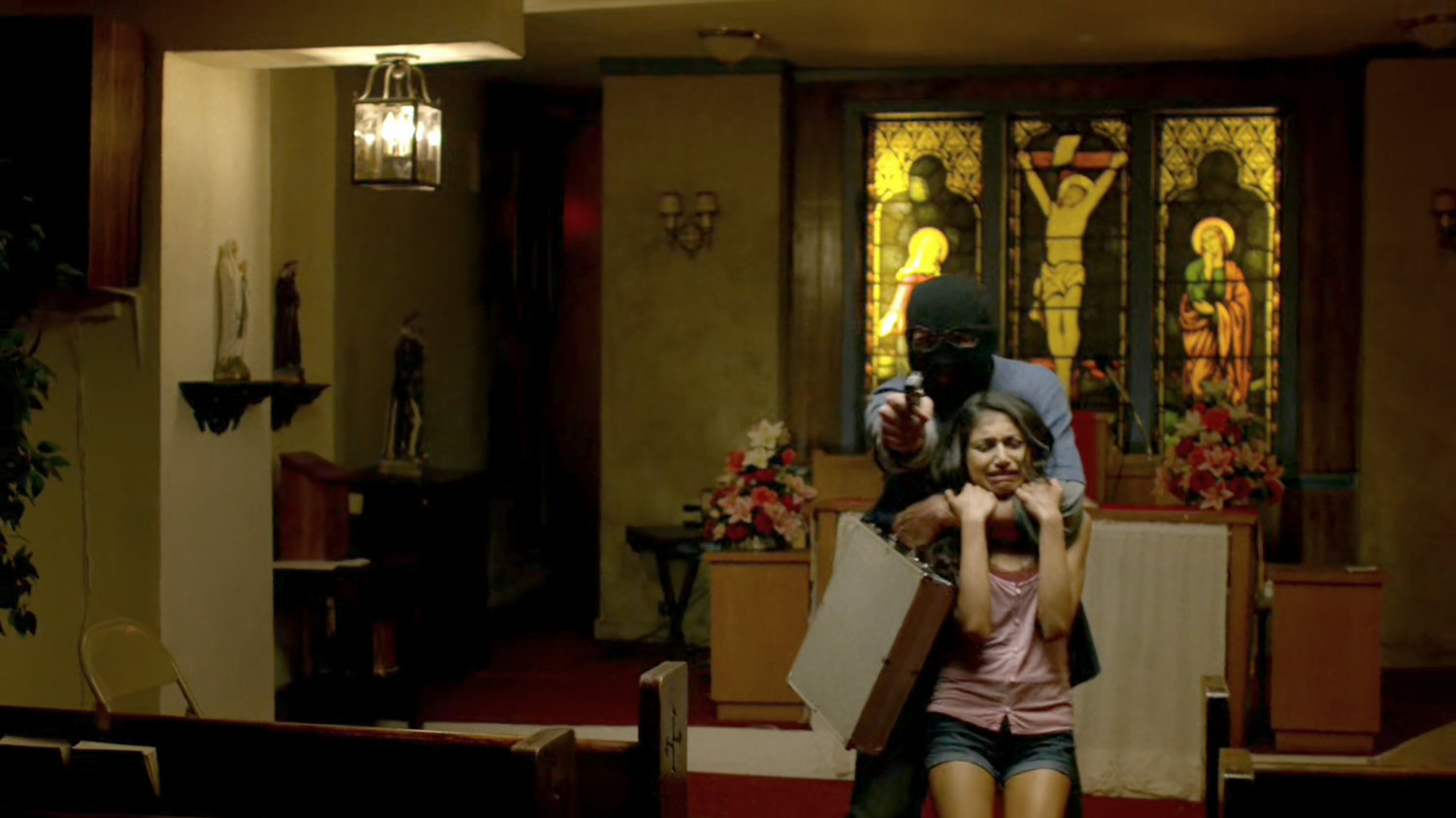 Diamond thief with a female hostage inside of the Parrish of the Angels Church.