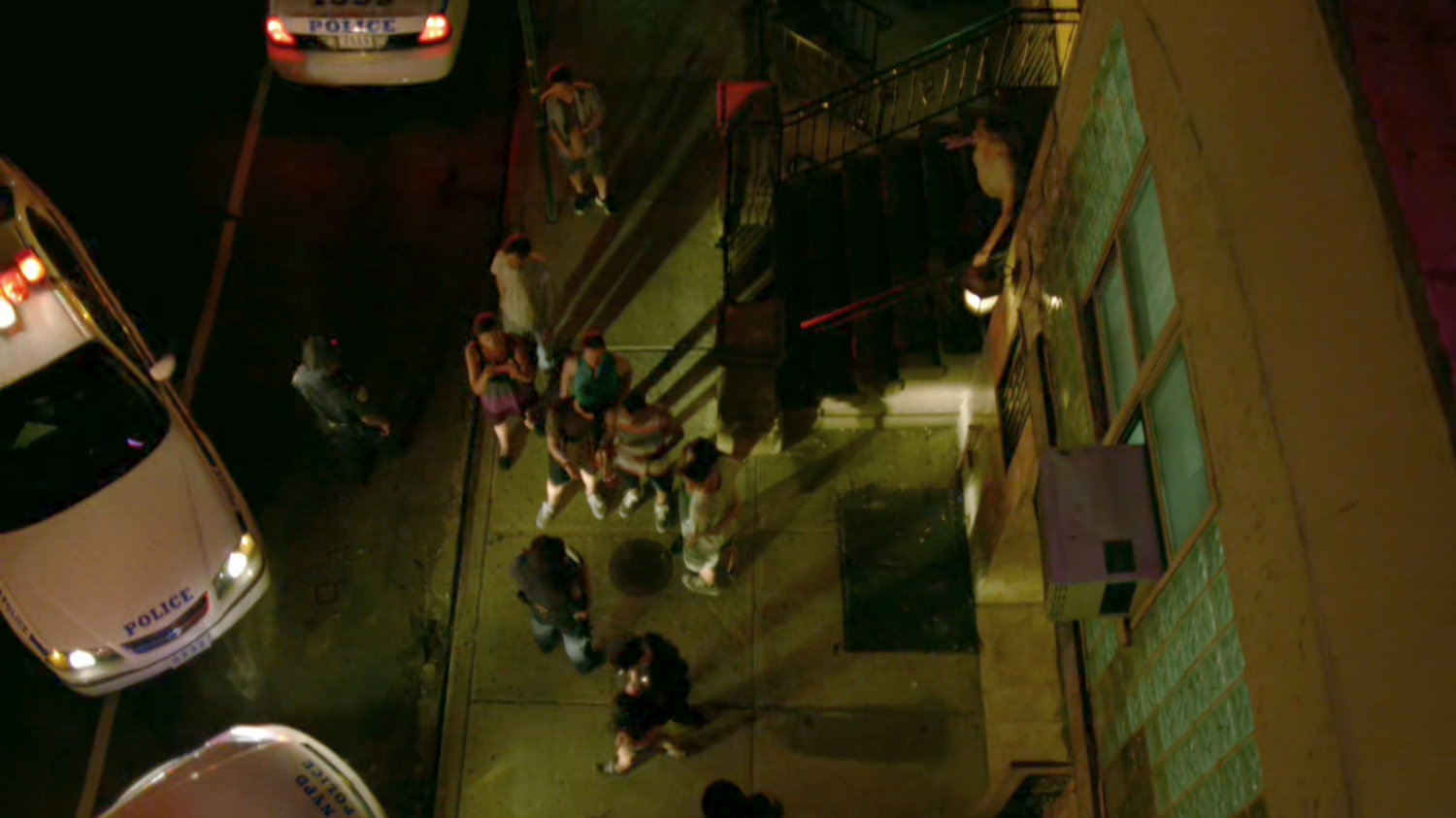 High angle view of police and thief on the sidewalk outside the Parrish of the Angels Church.