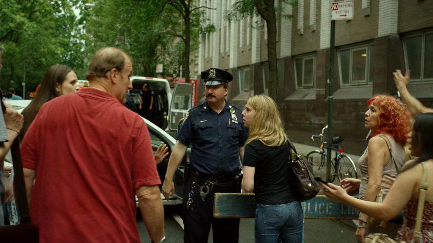 Police and onlookers outside Metro-General hospital exit.