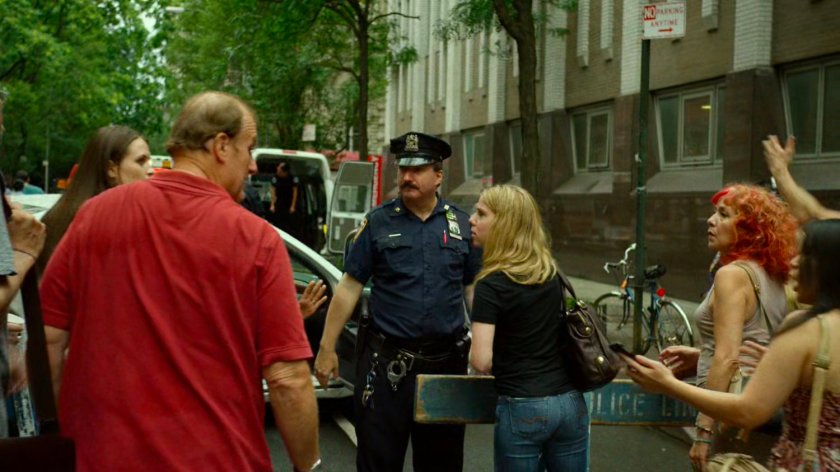 Police and onlookers outside Metro-General hospital exit.