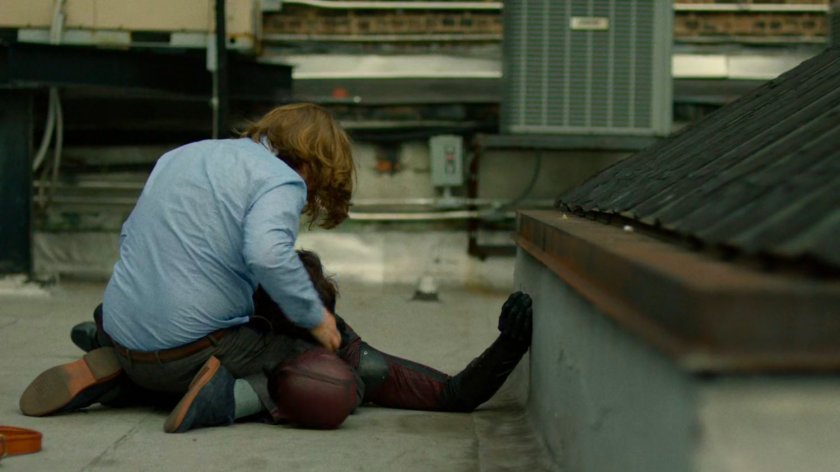 Foggy cradling Matt on rooftop.