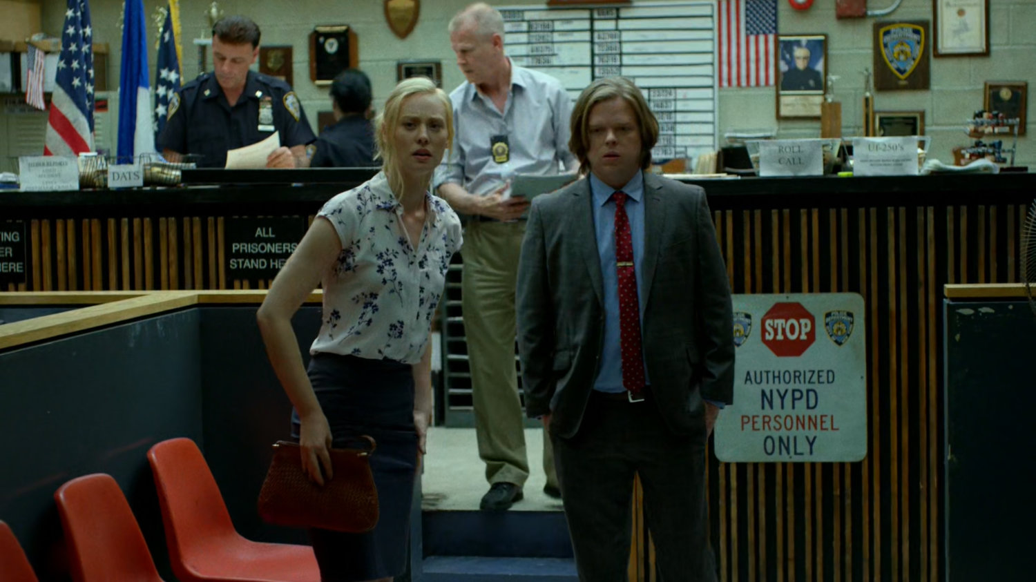 Foggy and Karen by the front desk of the 15th Precinct.