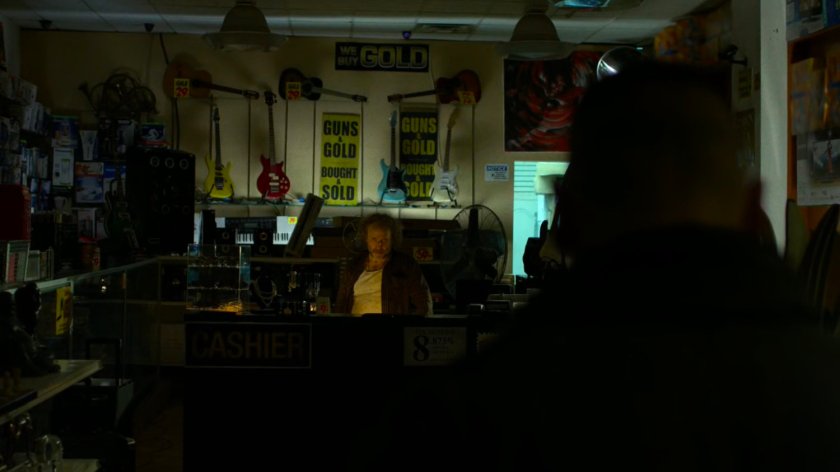 A dark silhouette approaches the pawn shop owner.
