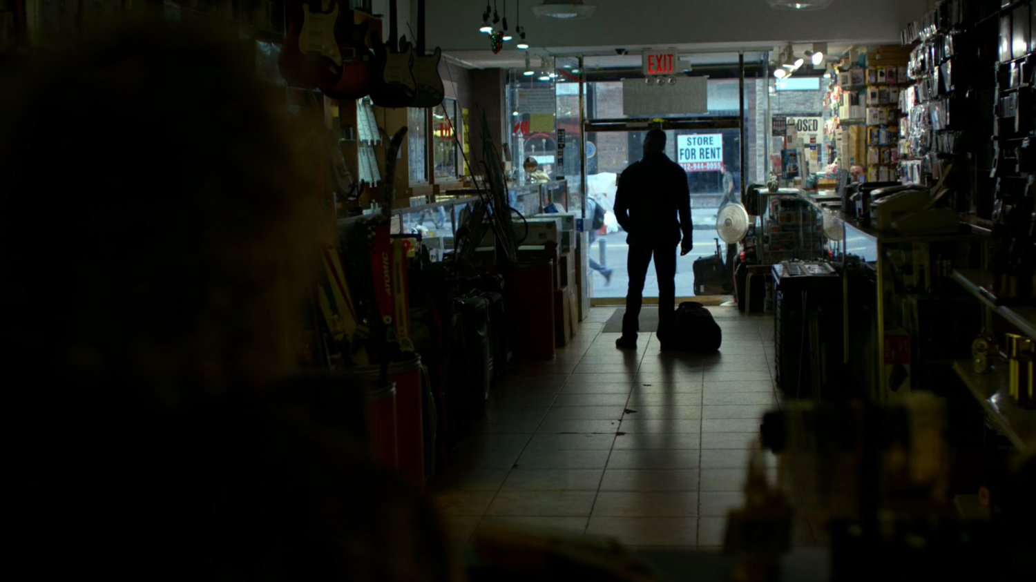 Frank Castle stops by the entrance to the pawn shop.
