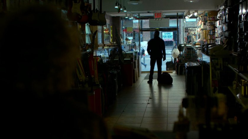 Frank Castle stops by the entrance to the pawn shop.