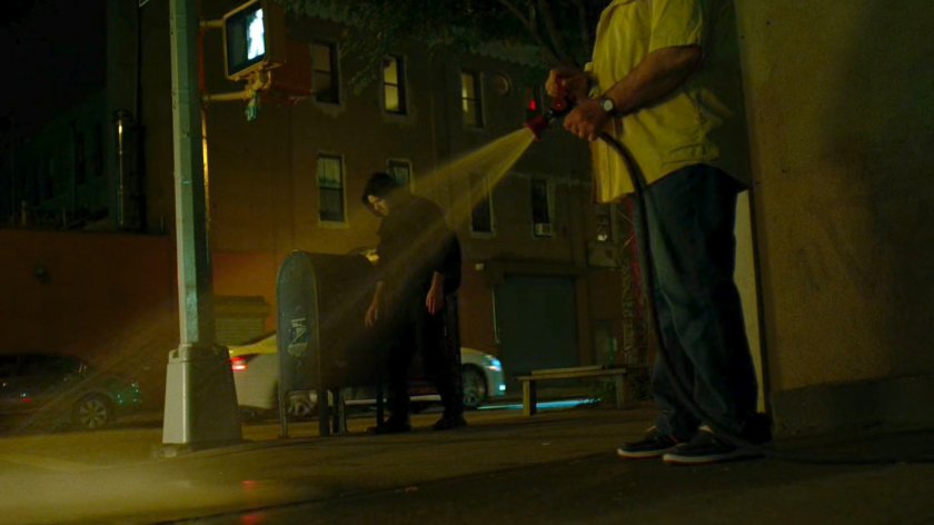 Matt losing the blood trail on a corner where a man is hosing off the sidewalk.