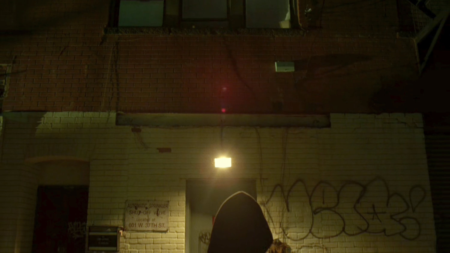 Matt looking at exterior of Frank Castle's apartment building.