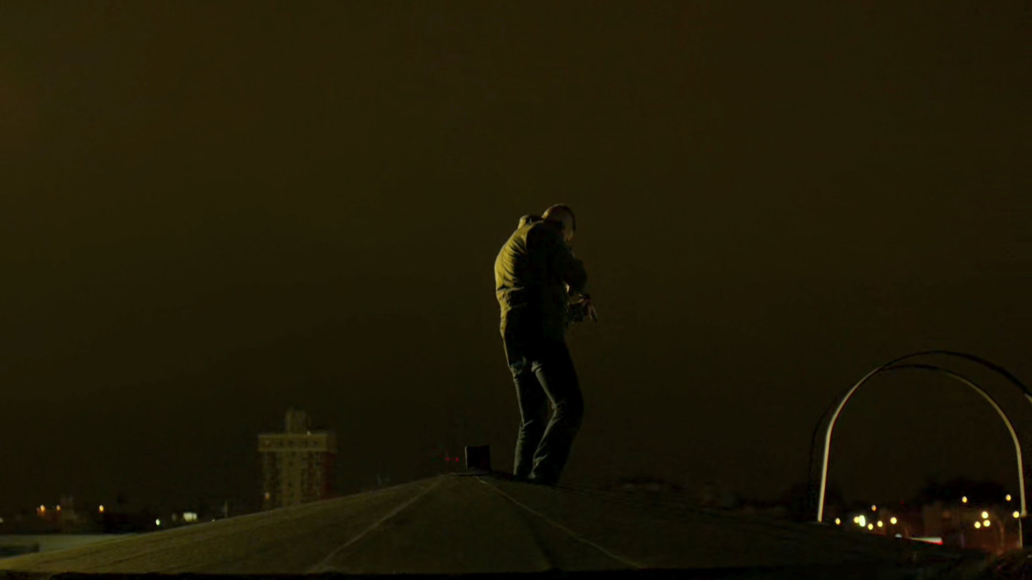 The Punisher atop a water tower aiming gun at police.