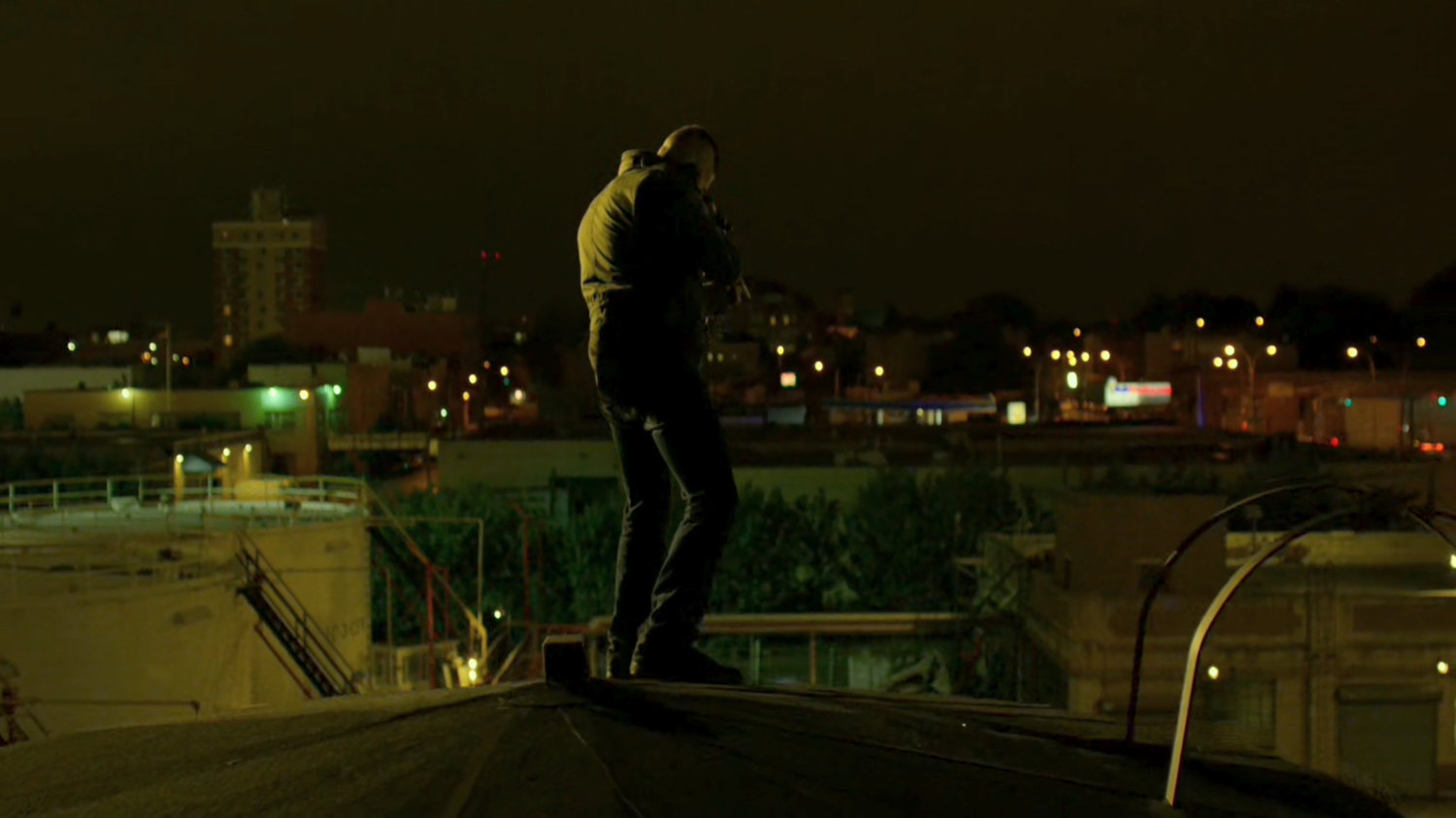 The Punisher atop a water tower aiming gun at police.