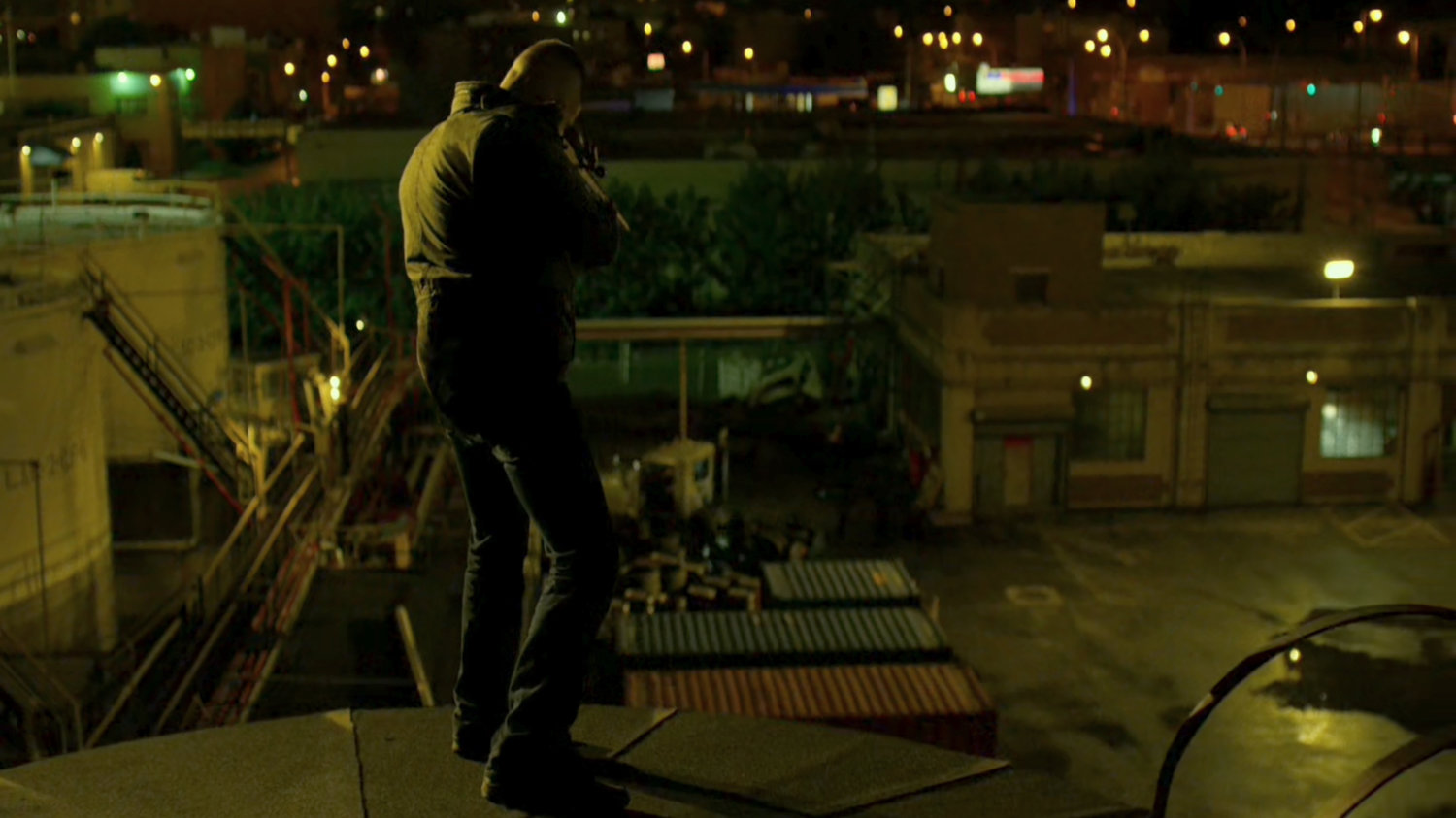 The Punisher atop a water tower aiming gun at police.