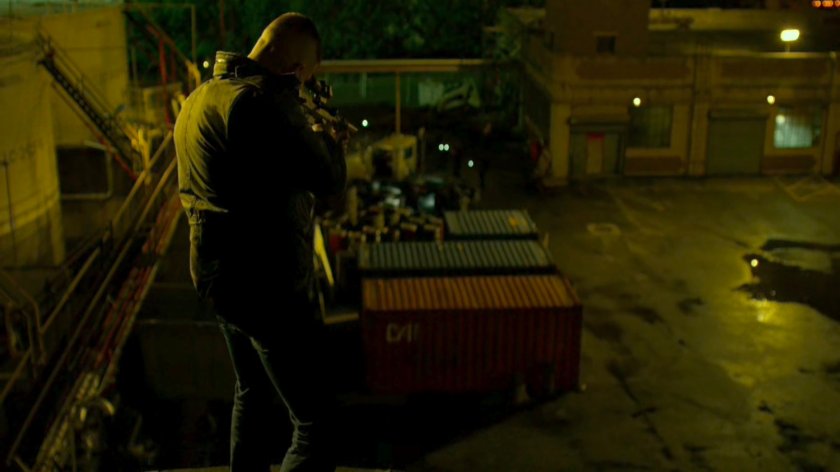 The Punisher atop a water tower aiming gun at police.