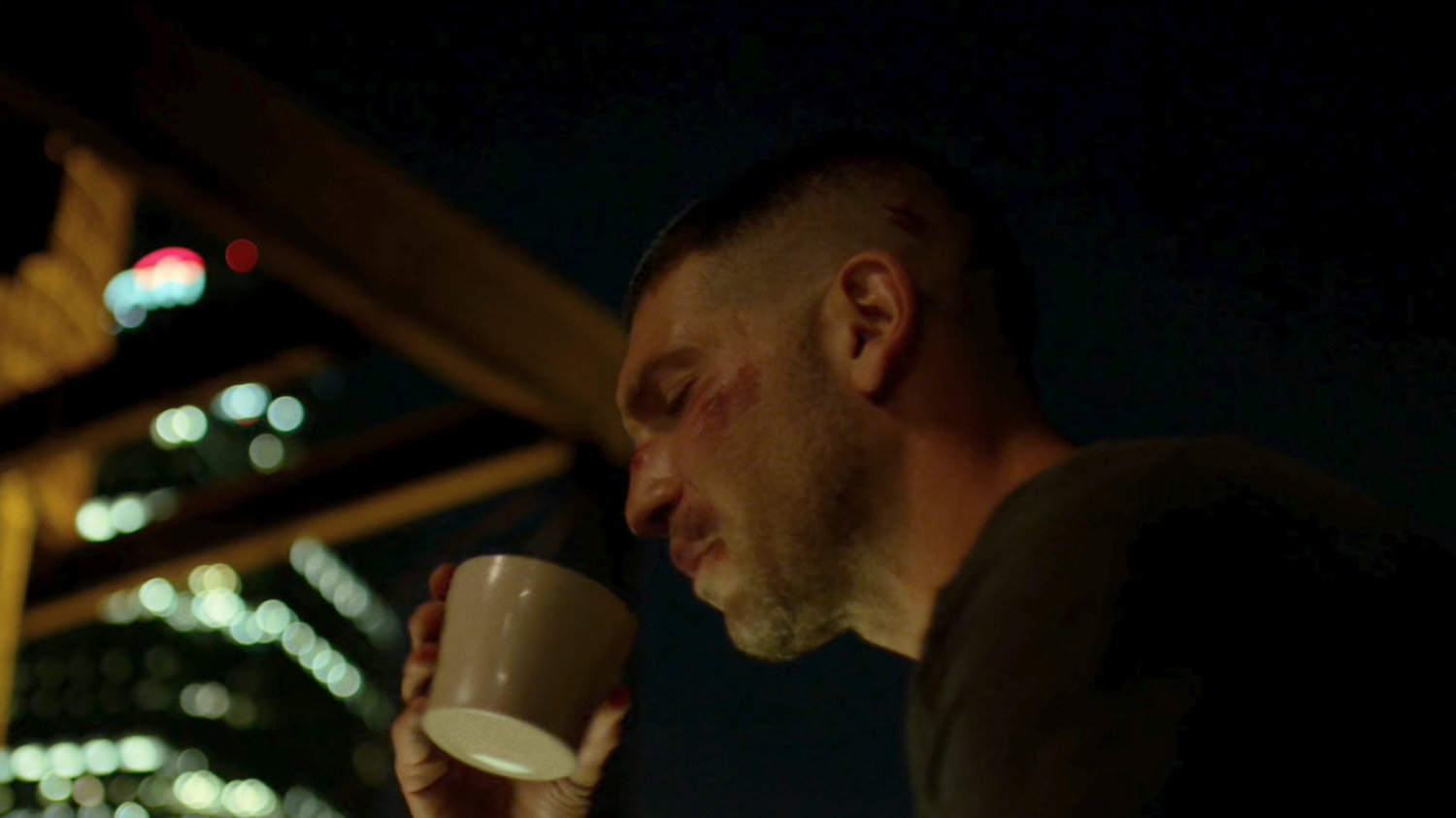 Frank Castle on a rooftop at nighttime.