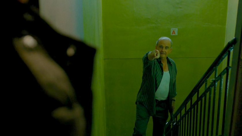 Jerry pointing at Frank Castle in stairway of building.