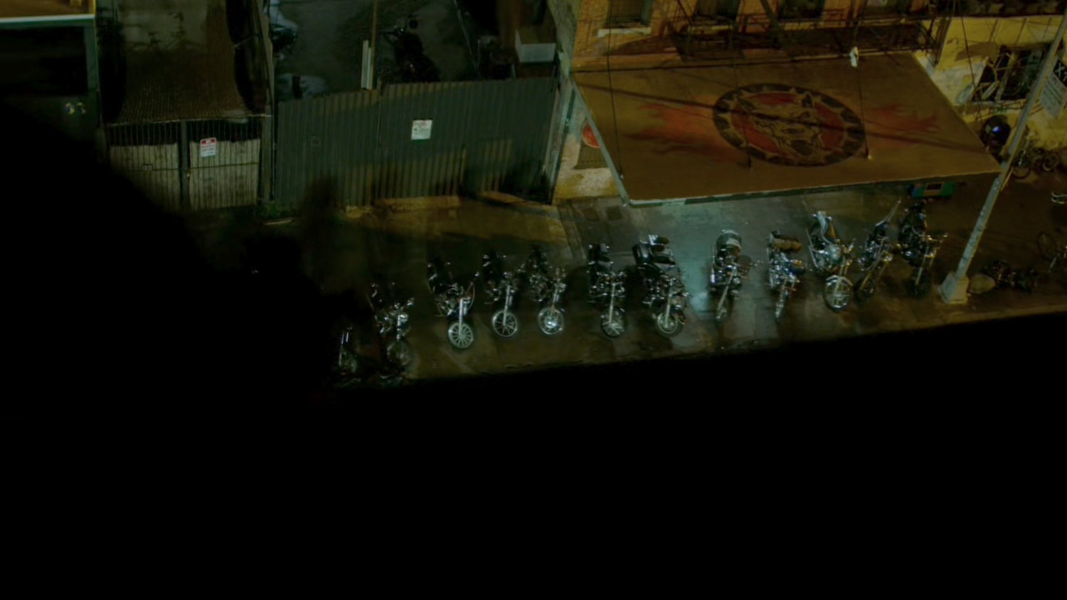 Aerial view of motorcycles parked outside Dogs of Hell bar.