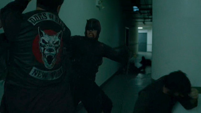 Daredevil fighting Dogs of Hell gang members in hallway.