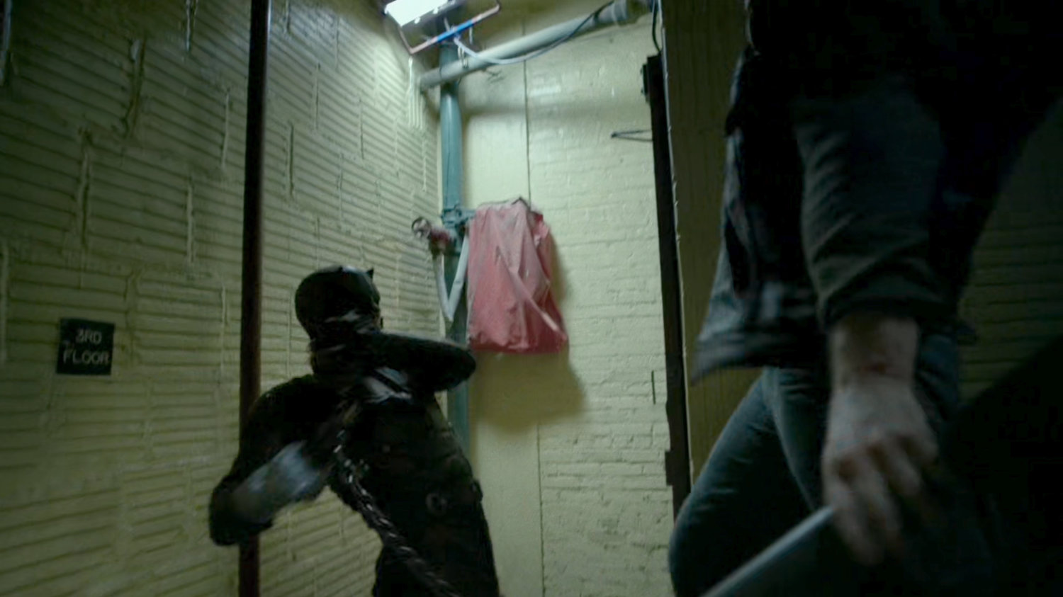 Daredevil fighting Dogs of Hell gang members in stairway.