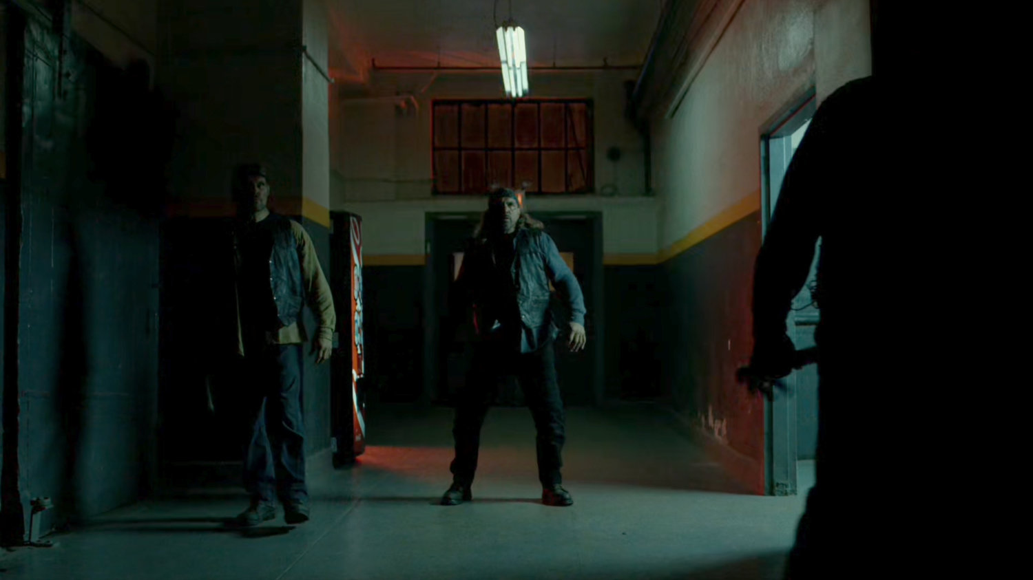 Daredevil confronted by Dogs of Hell gang members in entrance to building.