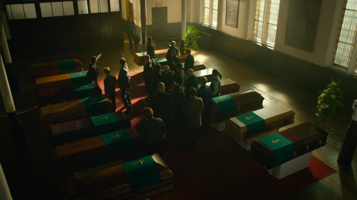 Members of the Kitchen Irish toast their dead friends in a church.