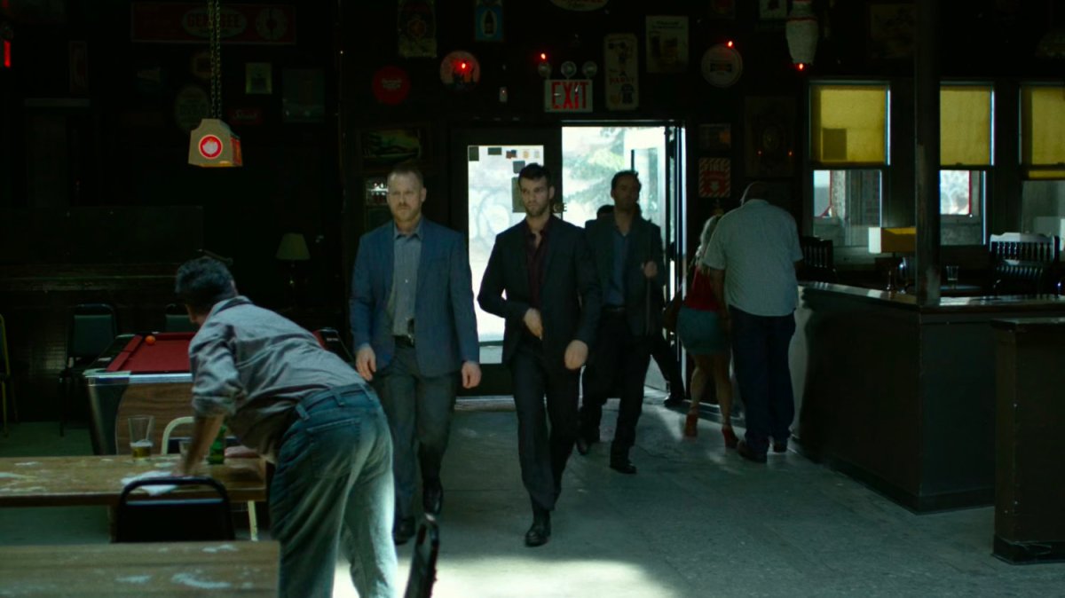 Kitchen Irish enter Stanley's Bar.