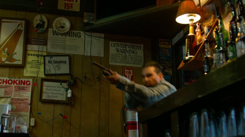 Man with shotgun in Stanley's Bar.