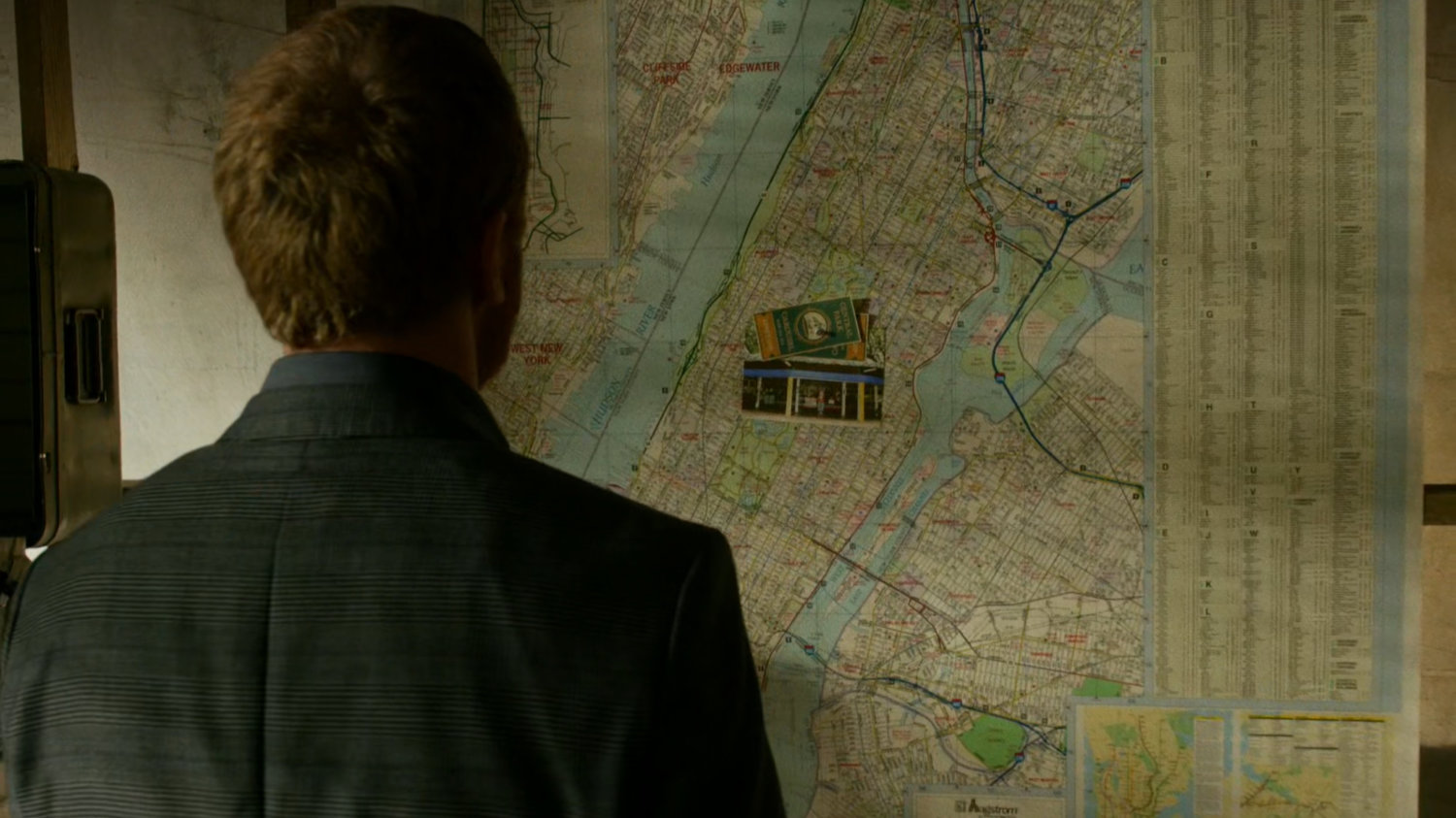 Finn looking at map of NYC in Frank Castle's apartment.