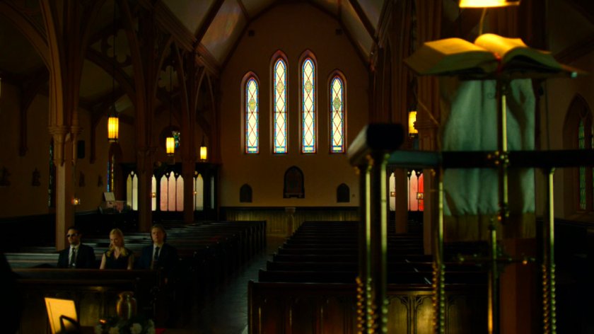 Matt, Karen, and Foggy sitting in church listening to eulogy.