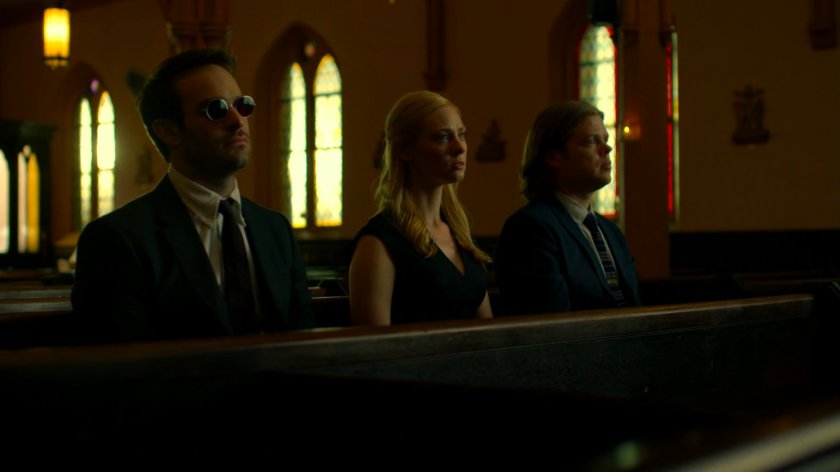 Matt, Karen, and Foggy sitting in church listening to eulogy.