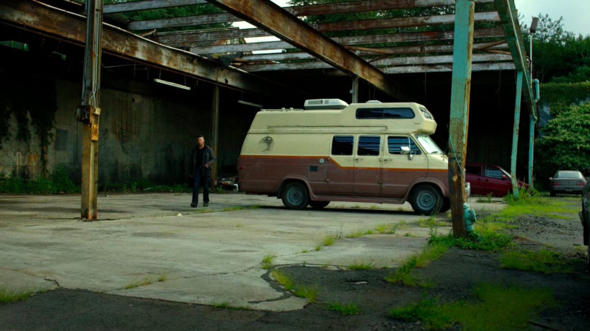 Frank Castle's camper parked under derelict structure.