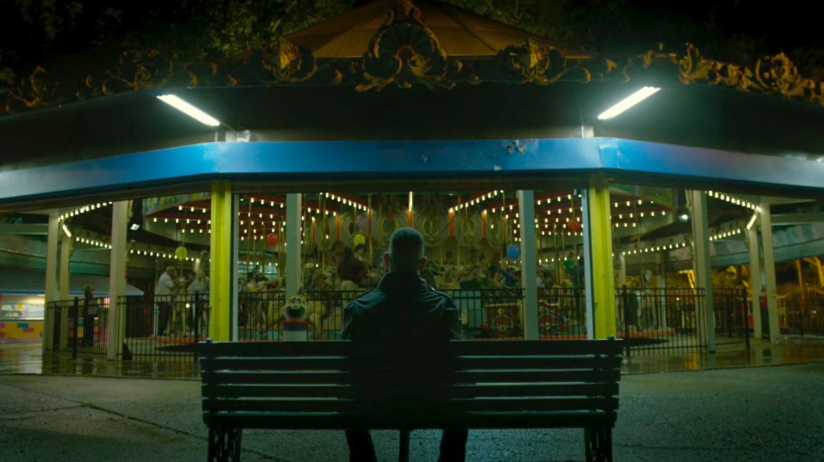 Frank Castle sitting in front of Central Park Carousel.