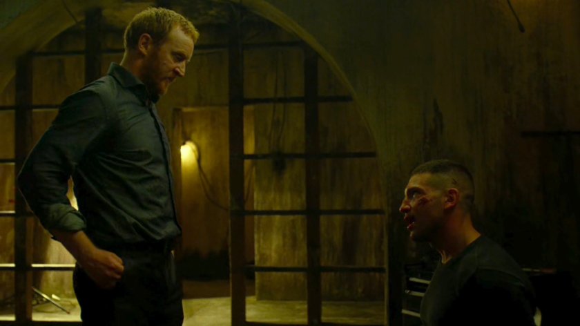 Finn talks to Frank tied to a chair in catacombs.