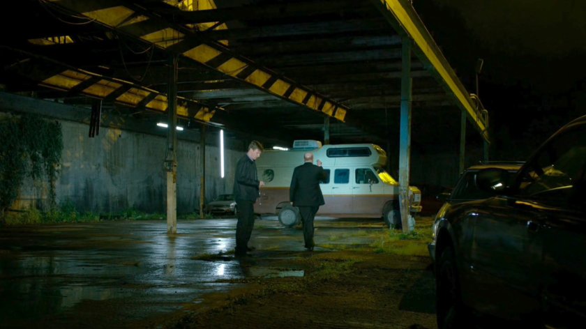 Men approaching Frank Castle's camper.